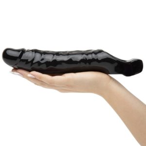 hand on sleeve take Black Penis Extender sleeve with Vibrating-product of delhisextoystore
